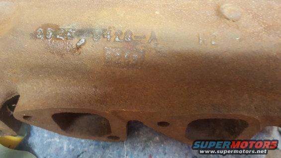 Rusty metal exhaust manifold with cast numbers '0625 0426-A'
