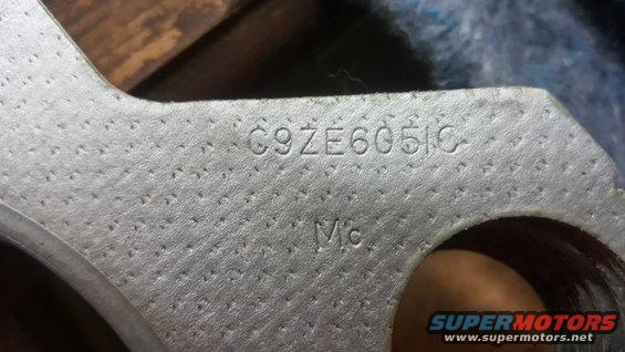 Close-up of a metal part with stamped numbers C9ZE6051C and MC