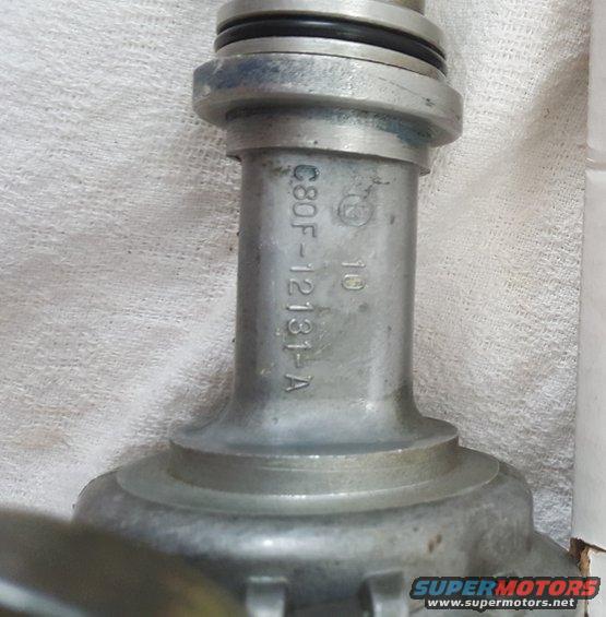 Metal automotive distributor cap with part number C8OF-12131-A stamped on it