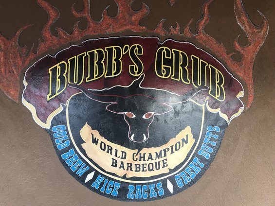 Mural of a bull's head with flames and text 'Bubbs Grub World Champion Barbeque'