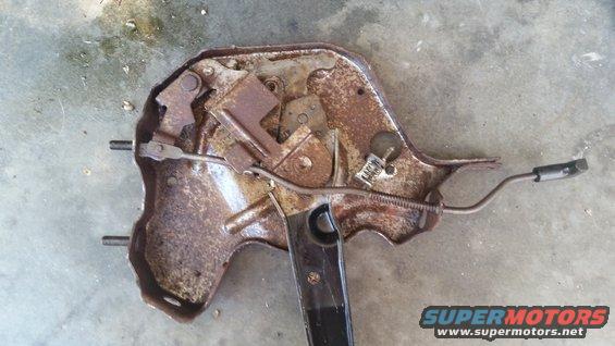 Rusted seat adjustment mechanism with black lever and cable