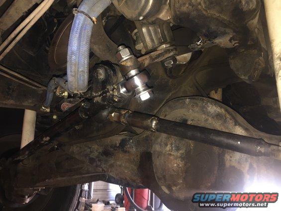 close-up of vehicle steering linkage and suspension components