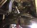 1984 Ford Bronco - Underside view of a vehicle's steering and suspension system, showing various metal parts and hoses.