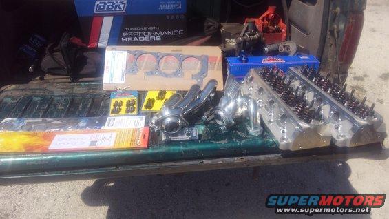 kimg0183.jpg Decided im going to do a 'revision' of sorts to the truck. i decided i do want the truck to have 4x4 again, make more power, and redo all the wiring to be more reliable. im going to do it all in steps because it is my daily driver still. 

in order to do a 4x4 swap i have  to get rid of my long tube headers which completly blocks the front driveshaft. however i am using GT40P cylinder heads which have a special spark plug angle making many headers not fit correctly. i decided instead of struggling with the plug angle issue, i would go ahead and replace the cylinder heads. 

so first step of this revision is going to be to swap the GT40P cylinder heads out and do all new exhaust. i am using Edelbrock E-street 5023 aluminum heads. the heads i already replaced the valve springs for K-Motion K-750 for my roller cam. i am using Scorpion 1.72 ratio roller rockers in order to get some extra from my Comp 35-512-8 cam which should give me 0.516&quot; lift instead of the 0.480&quot; i originally had.