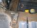 1986 Ford Bronco - Vehicle interior floor shows rust damage and tools, including a DeWalt tape measure and a socket extension.