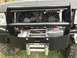 1989 Ford Bronco - Vehicle front end shows a winch, radiator, and cooling fans mounted behind a bull bar.