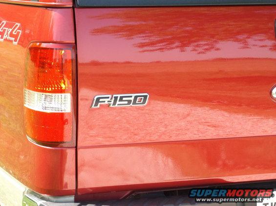 Red Ford F-150 tailgate with F-150 badge and 4x4 decal