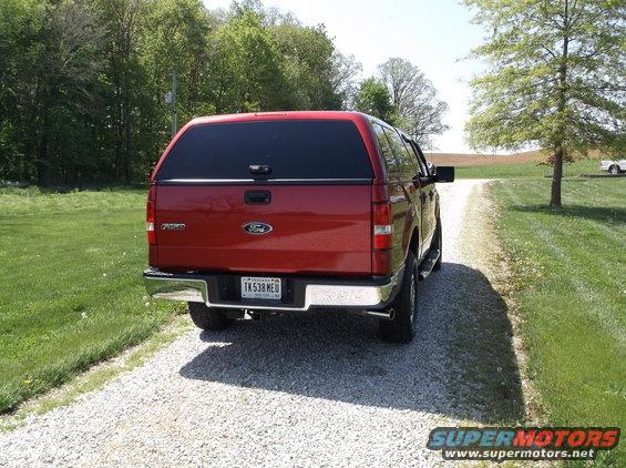 Red 2008 Ford F-150 pickup truck with a cap, rear view