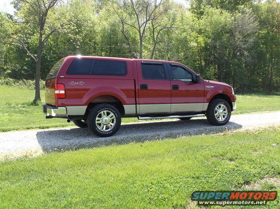 Red 2008 Ford F-150 pickup truck with a cap, side view
