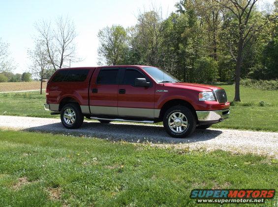 Red pickup truck with a cap, 3/4 front view