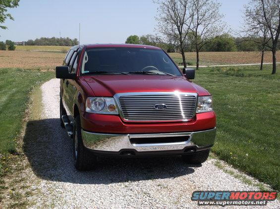 Red 2008 Ford F-150 front view with chrome grille