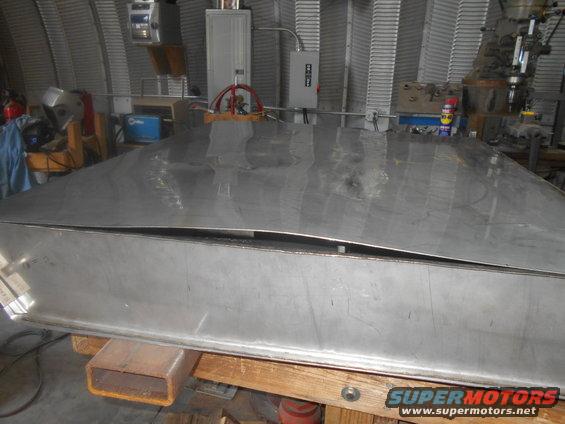 Bent sheet metal panel on wooden supports in a workshop