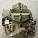 1968 Mercury Cougar - A close-up view of a Holley carburetor, showing various mechanical components and stamped part numbers.