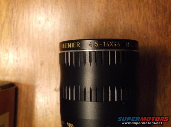 Black scope with gold lettering reading PREMIER 4.5-14X44 MIL-DOT