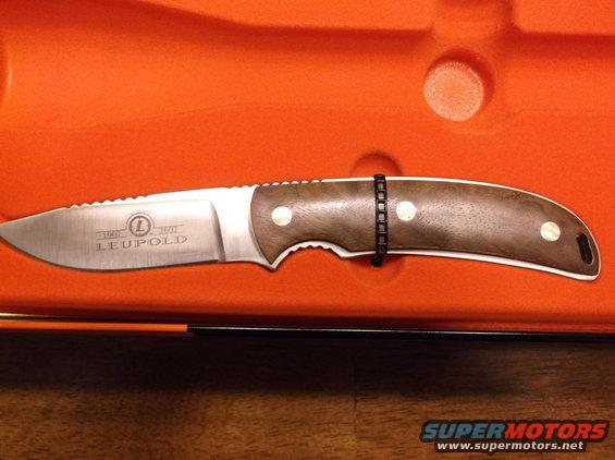 Knife with wood handle and serrated edge, marked LEUPOLD