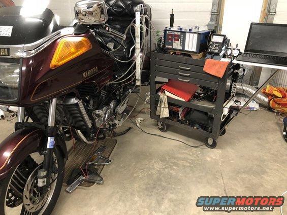 Maroon 1983 Yamaha Venture motorcycle hooked up to diagnostic equipment on a rolling cart