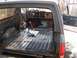 1986 Ford Bronco - The interior of an SUV has been stripped down, revealing the metal floor and dashboard components.