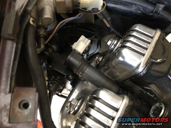 Close-up of motorcycle engine components, including wiring and chrome covers