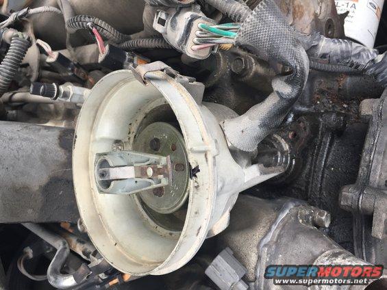 Close-up of a vehicle's engine distributor cap and rotor assembly