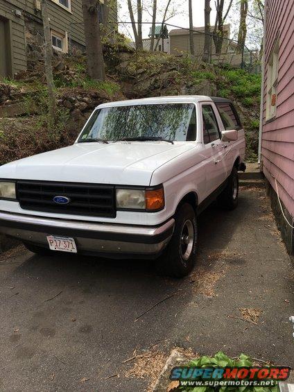 White Ford Bronco parked on asphalt, front 3/4 view, showing a license plate reading P17 371