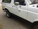 1990 Ford Bronco - Side view of a white 1990 Ford Bronco, parked outdoors on a paved surface.