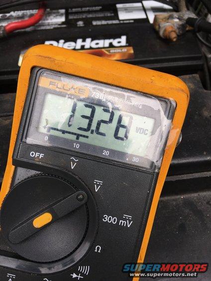 Multimeter reads 13.26 VDC on car battery