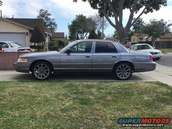 Silver sedan parked on a residential street, side view