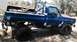 1979 Chevrolet C/K Pickup - This 1979 Chevrolet C/K Pickup features a roll bar and lifted suspension, with a two-tone blue and white paint scheme.