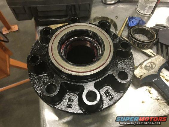 Black wheel hub with bearing and "GM" marking