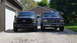 1987 Ford Bronco - Two Ford trucks are parked side-by-side in front of a garage and house.
