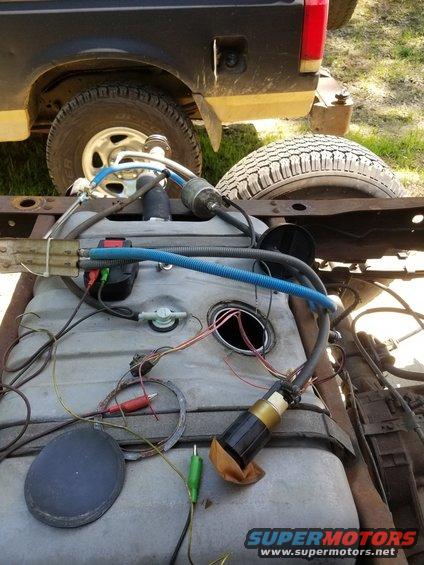 Emptying the tank into mine, using an old fuel pump (probably from a Crown Vic tank), the battery pack from my cheapo cordless impact, & some old Bronco fuel lines.