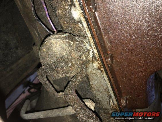 Rusty transmission part with wiring and a Supermotors.net watermark
