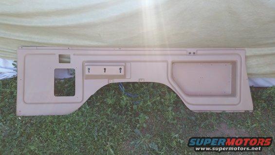 Tan interior panel with wheel well cutout and three key hooks