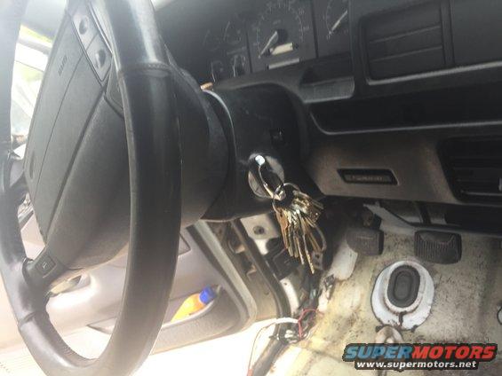 Keys in ignition of a vehicle interior, dashboard and steering wheel visible