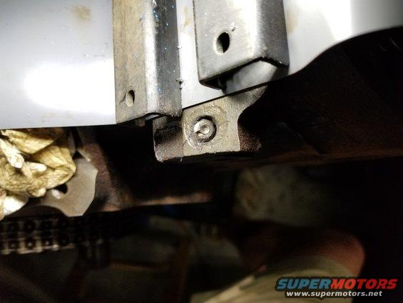 The driver's side bolt sheared at an angle, making it harder to find center.  I had to dig the corrosion out of the pocket first, die-grind the top flat, punch center, and then drill as before.

See the PREVious & NEXT few pics...