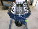1969 Ford Mustang - A blue V8 engine is mounted on an engine stand, with its internal components visible from above.