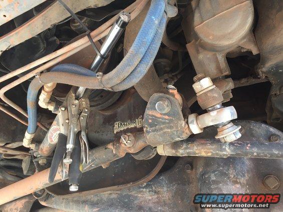 Close-up of vehicle steering linkage with vice grips attached