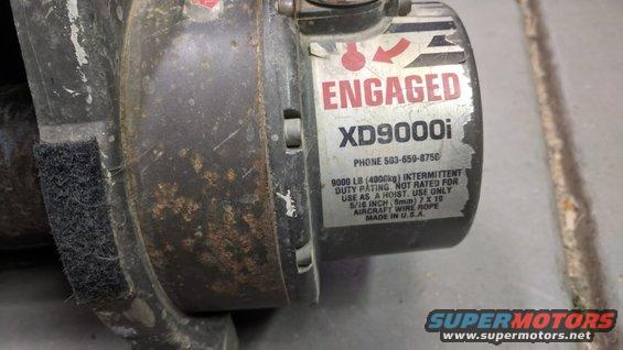 Winch with label showing 'ENGAGED XD9000i' and specs for 9000 lb capacity