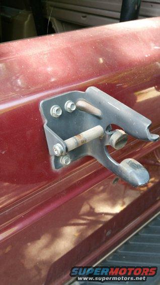 1996 Ford Bronco rear tire carrier mount on dark red body panel