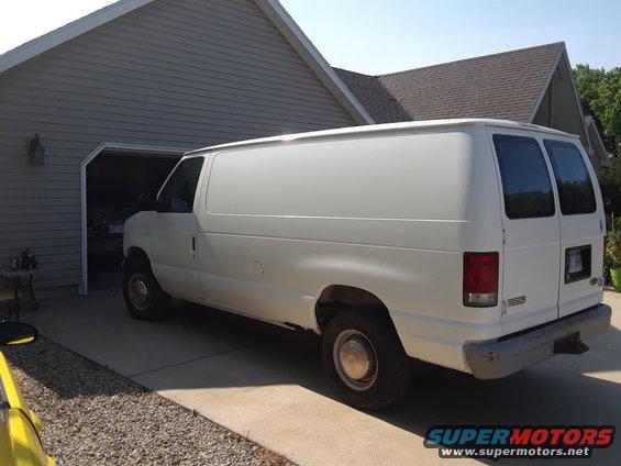 White 1999 Ford E250 cargo van, rear 3/4 view