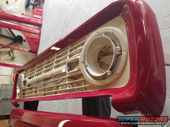 Red 1968 Ford Bronco grille and fender assembly, partially painted
