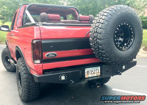 Red 1994 Ford Bronco rear view with spare tire on bumper