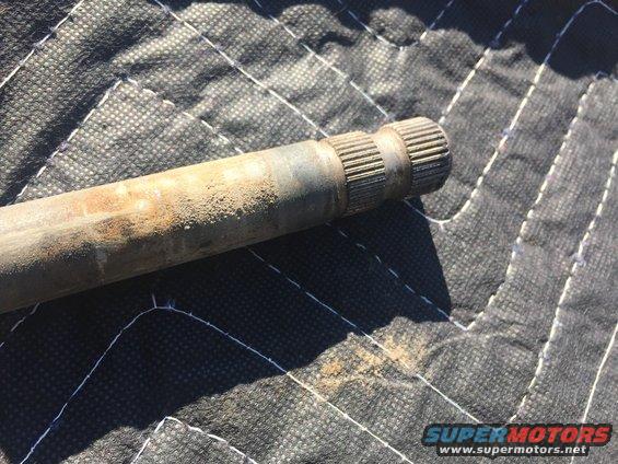 Axle shaft with splined ends on a quilted surface