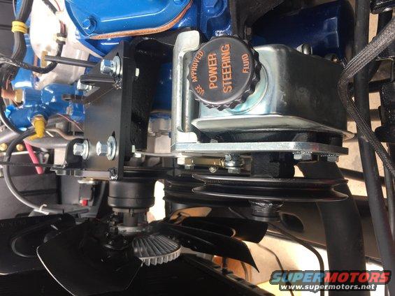 Close-up of power steering fluid reservoir and fan assembly on an engine