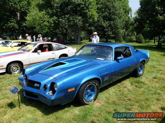 Blue 1978 Chevrolet Camaro Z28 parked on grass with a white car behind it