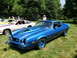 1971 Ford Ranchero - A blue Chevrolet Camaro Z28 is displayed on a sunny day at an outdoor car show.