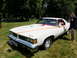 1971 Ford Ranchero - White 1976 Pontiac Grand Am on display at an outdoor event.