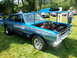 1971 Ford Ranchero - A blue Dodge race car with custom graphics and an open hood is parked on grass at an outdoor event.