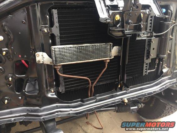 Transmission cooler mounted in front of radiator, part of vehicle's cooling system