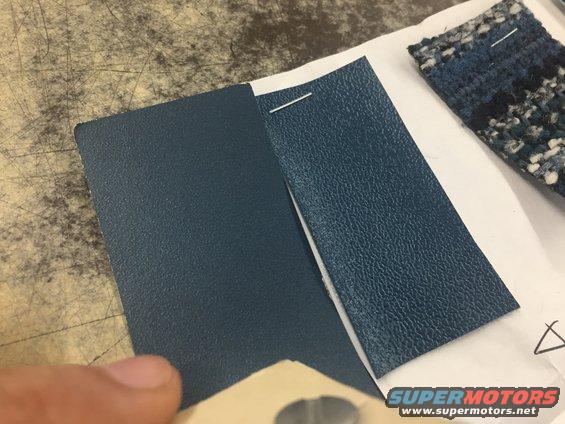 Two blue textured interior trim samples pinned to white paper, with a sample of patterned fabric to the right